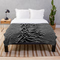 Plush blanket featuring the iconic abstract album art design of the Unknown Pleasures album