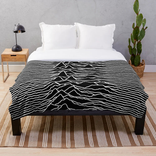 Plush blanket featuring the iconic abstract album art design of the Unknown Pleasures album