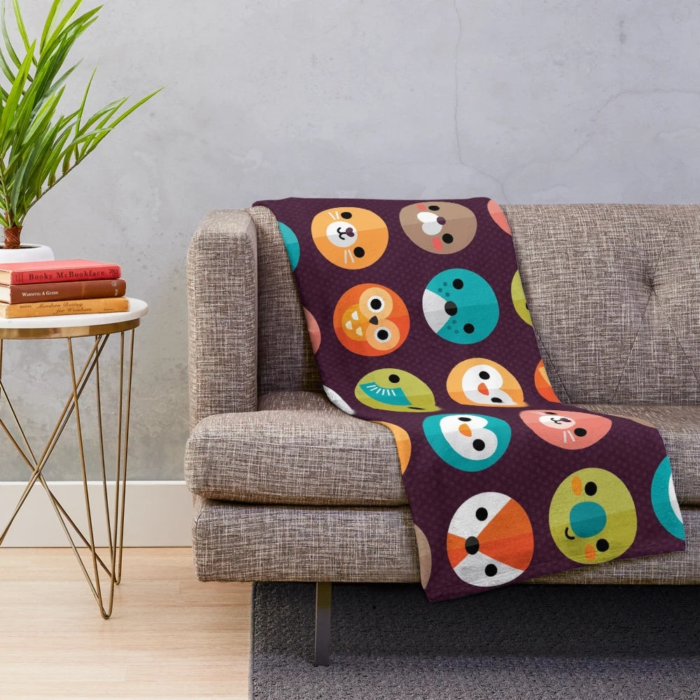 Smiley faces and cute animal designs on a soft, plush blanket
