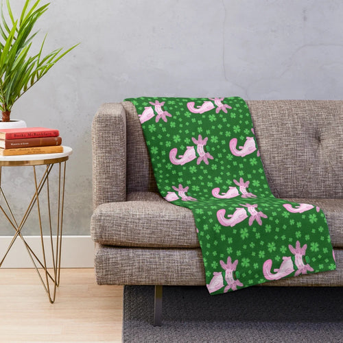Cozy green and white plush blanket featuring an adorable axolotl design and clover pattern