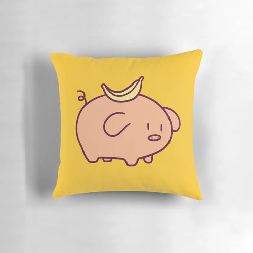 Closeup of a soft, plush pillow in the shape of a cute, chibi-style banana-colored pig.
