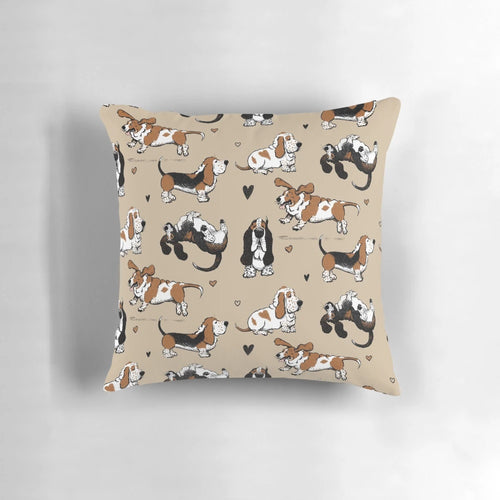 Pair of Basset Hound puppies cuddling on a tan pillow