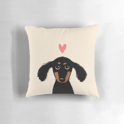 Cute dachshund puppy lying on a heart-shaped pillow