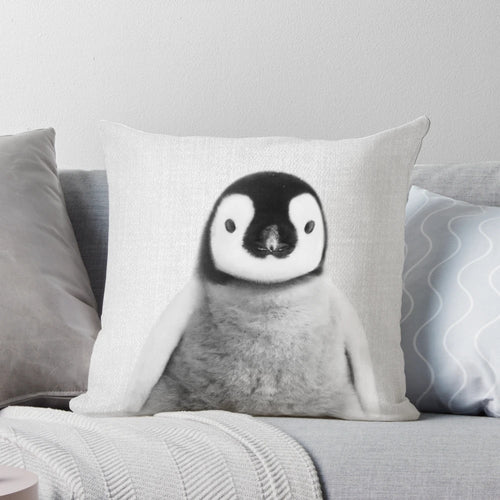 Monochrome photograph of a baby penguin on a decorative black and white throw pillow