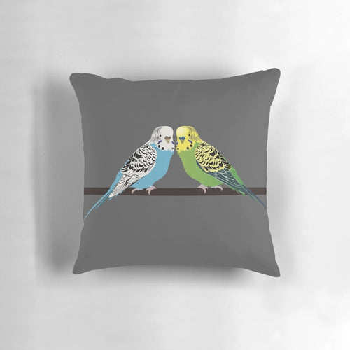 Closeup image of a blue parakeet on a decorative pillow