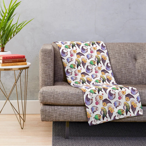 Soft and cozy plush blanket featuring a pattern of cute budgies and cockatiels