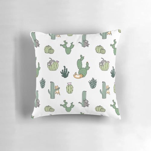 Colorful pillow featuring cute cats among cacti plants