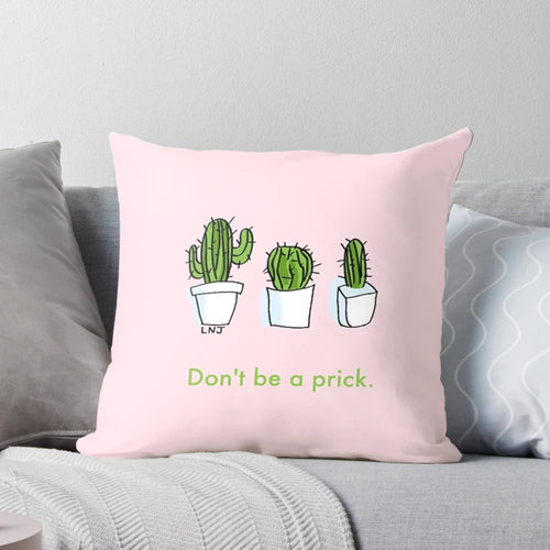 Three pink and green smol cartoon cactus plants on a decorative throw pillow