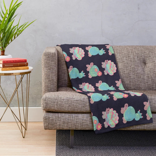 Plush cactus tortoise blanket with a cute, smiling design