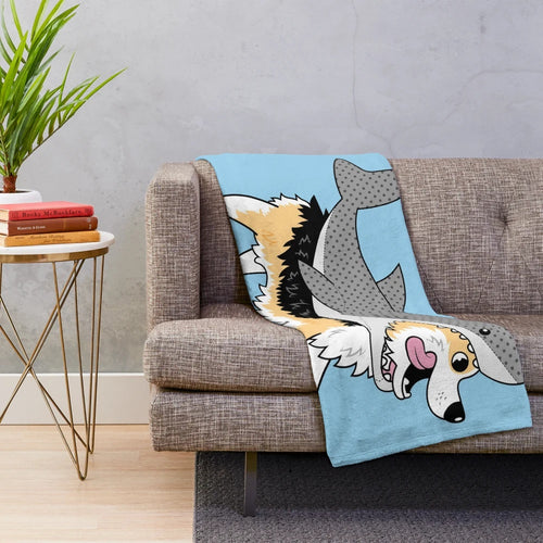 Corgi dog wearing a shark costume on a plush blanket