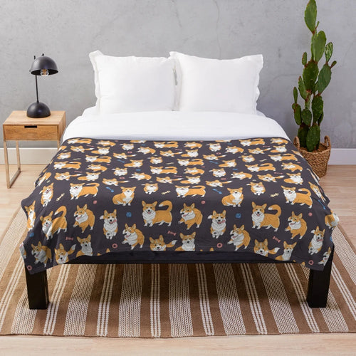 Cute Corgis playing on a grey plush blanket