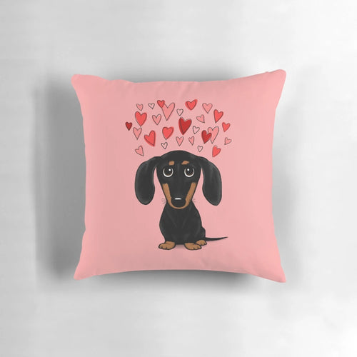 A Dachshund (wiener dog) pillow with Valentine's Day hearts in red and pink colors.