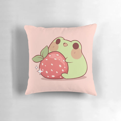Soft, plush pillow featuring a cute, kawaii-style frog sitting on a strawberry against a pastel, cottagecore-inspired background