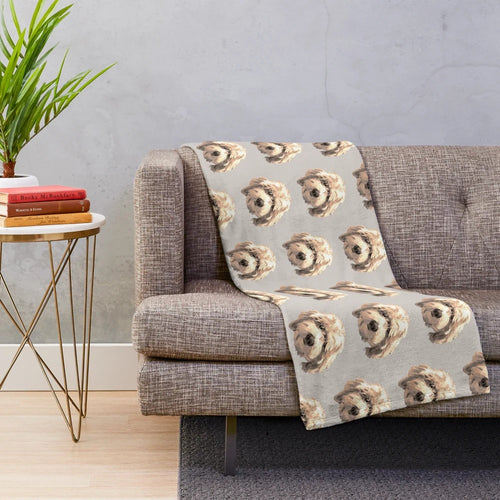 Soft and cuddly golden labradoodle face on a plush blanket