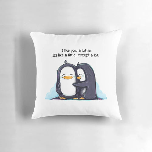 Cute and cuddly penguins hugging on a soft, plush pillow with the text 'I Like You a Lottle'