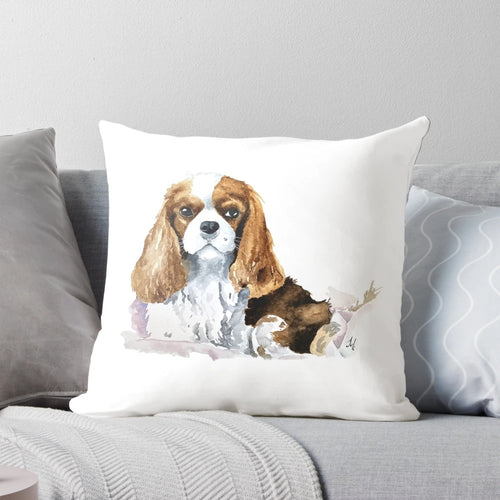 Charming King Charles Cavalier puppy on a soft, plush pillow