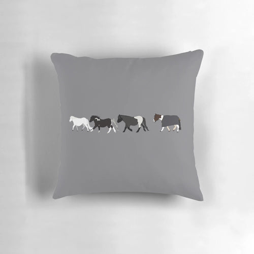 A plush, mini parade pillow featuring a design of small, playful horses.