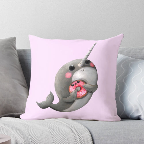 Cute plush narwhal with donut throw pillow, perfect for decorating a child's room or nursery.