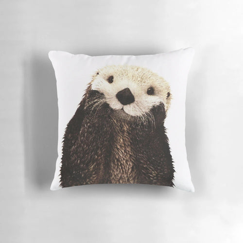 Soft, plush pillow featuring a playful otter with a big smile, perfect for adding a touch of whimsy to any room.