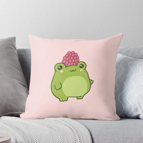 Soft, plush pillow featuring a pastel raspberry colored frog in a cute and chubby cottagecore style design.