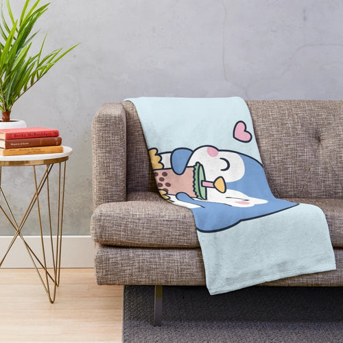 Cute penguin holding a boba tea cup on a soft, cozy plush blanket