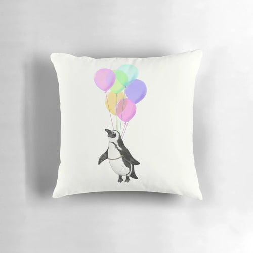 Soft, plush penguin-shaped pillow in black, white and pink with a whimsical balloon design, perfect for a baby nursery or child's bedroom.