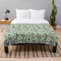 Soft and cozy plush blanket featuring a cute green quokka pattern