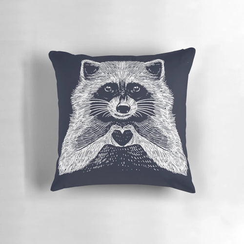 Soft, plush raccoon-shaped pillow with a heart-shaped face and whimsical, hand-drawn illustration
