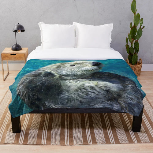 Soft and cuddly sea otter plush blanket with a cute blue water design