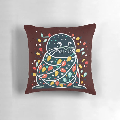 Cute and funny seal wearing a santa hat on a Christmas tree-shaped pillow