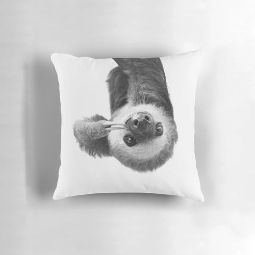 Soft and cuddly sloth-themed pillow with a whimsical black and white design, perfect for a child's nursery or bedroom.