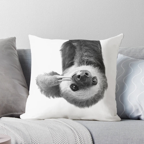 Soft and cuddly sloth-themed pillow with a whimsical black and white design, perfect for a child's nursery or bedroom.