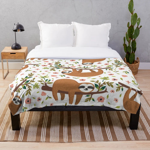 Soft and cuddly sloth plush blanket featuring a cute, cartoon-style sloth design