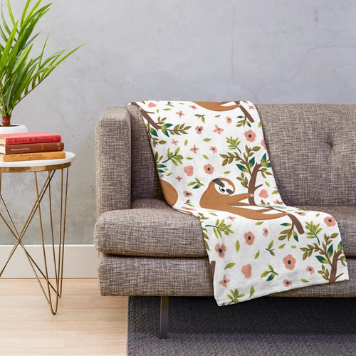 Soft and cuddly sloth plush blanket featuring a cute, cartoon-style sloth design