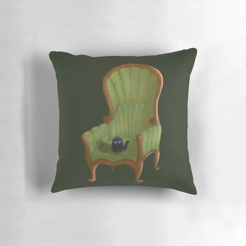 Cute small cat sitting on a pink chair pillow