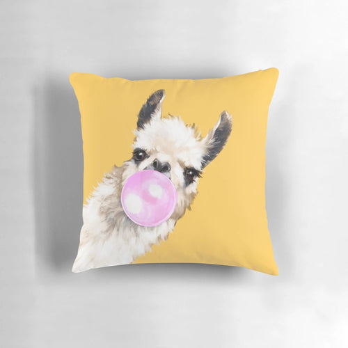 Mustard yellow pillow with a cute and sneaky llama blowing bubble gum