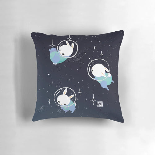 Colorful digital illustration of cute space bunnies or rabbits on a throw pillow