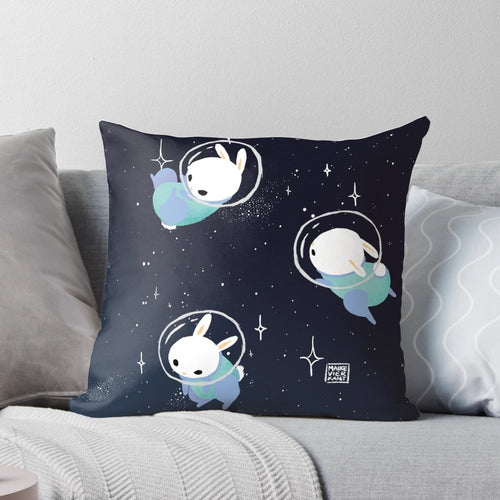 Colorful digital illustration of cute space bunnies or rabbits on a throw pillow