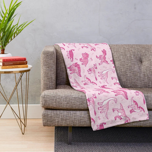 Sparkly dinosaur plush blanket featuring a seamless pattern of cute jurassic animals