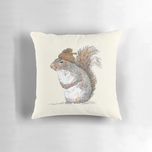 Illustration of a cute, whimsical squirrel wearing an acorn-shaped hat on a decorative pillow.