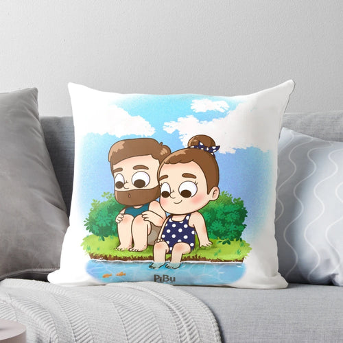 Two people cuddling on a beach with a colorful, kawaii-style pillow