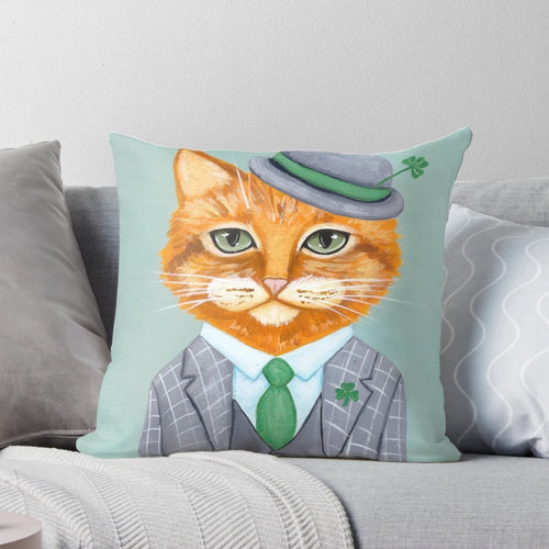 Tiarnan the Tabby Cat Pillow wearing a green shamrock suit and clover accessories