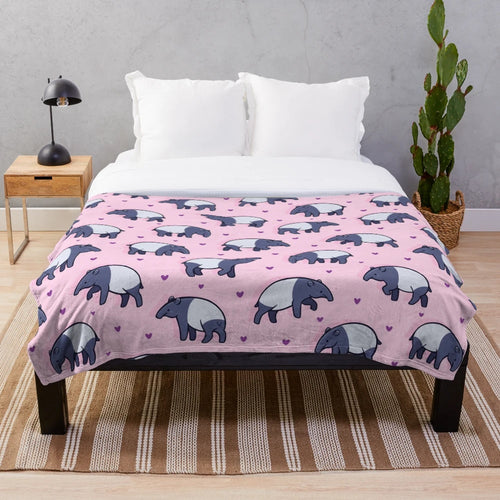 Soft and cuddly plush blanket featuring a cute tapir with a heart pattern design