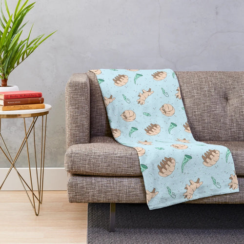 Tardigrades and other cute microscopic animals printed on a soft, plush blanket