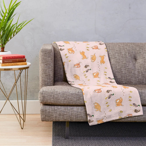 Soft pink plush blanket featuring cute cartoon illustrations of Nova Scotia duck tolling retriever puppies and mallard ducklings
