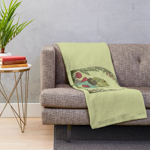 Cute vintage-style plush blanket featuring a frog playing a banjo on a mushroom, embodying a cottagecore aesthetic