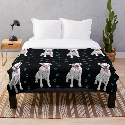 White boxer dog on a cozy plush blanket