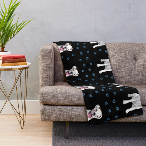 White boxer dog on a cozy plush blanket