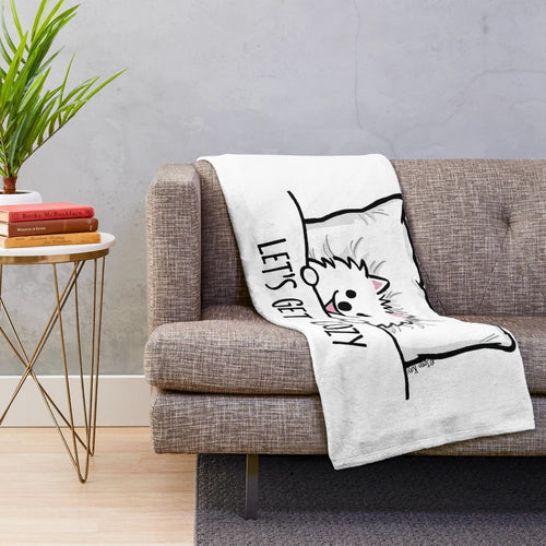 Cute cartoon-style white pomeranian dog on a plush blanket