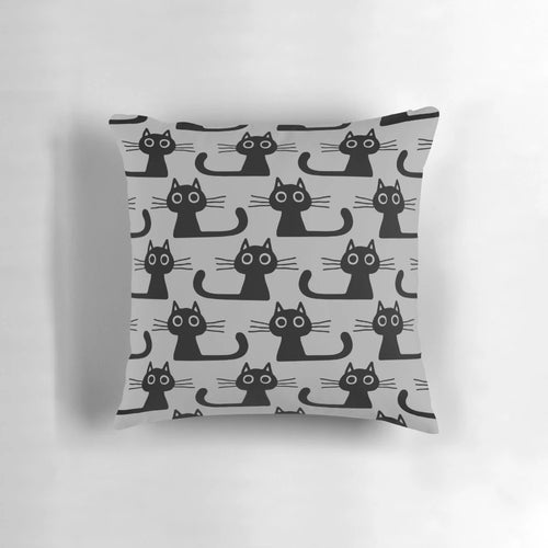 Soft, plush black kitten pillow with wide eyes and cute expression